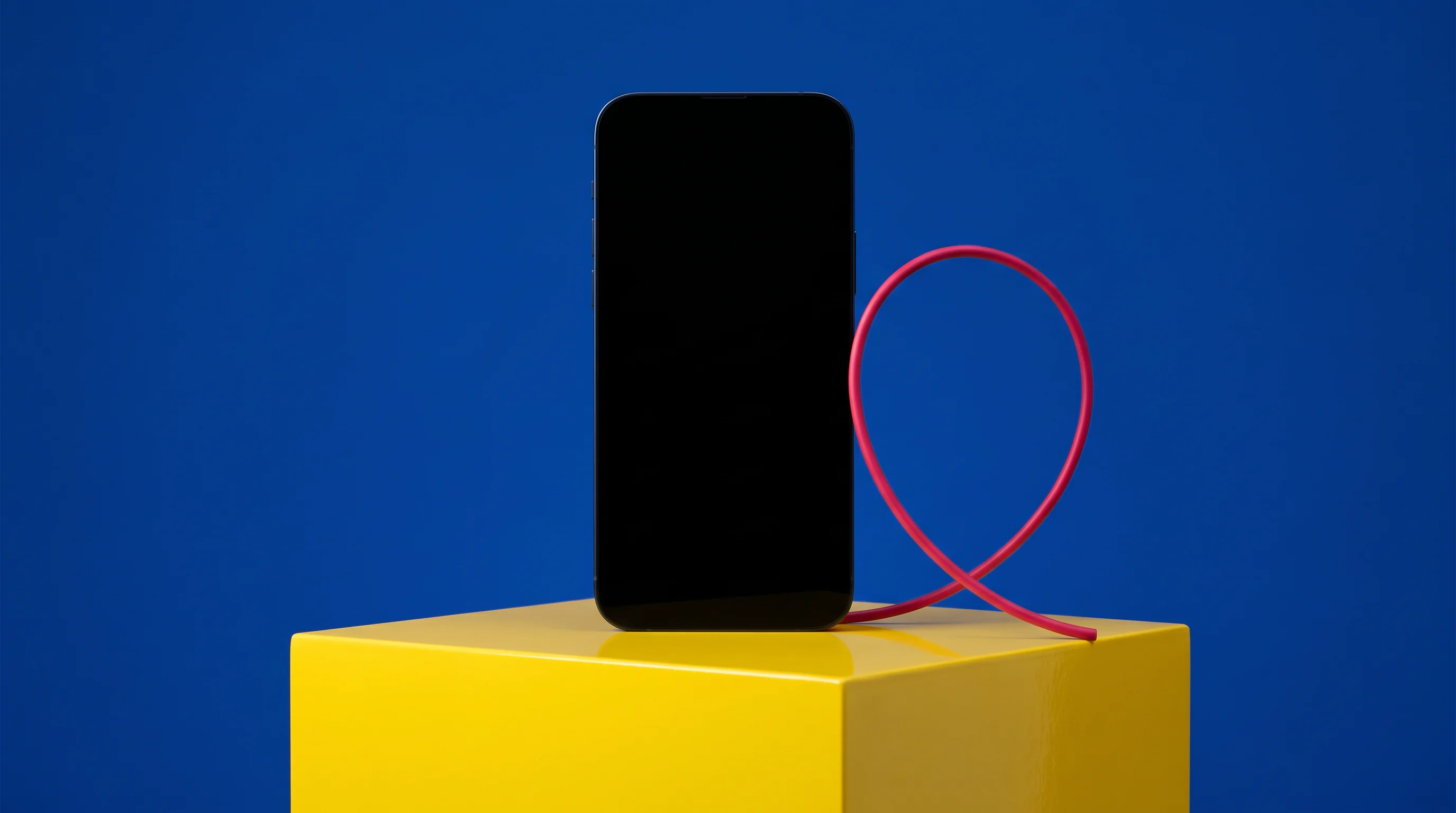 Black handset displayed on yellow and blue plinth blocks